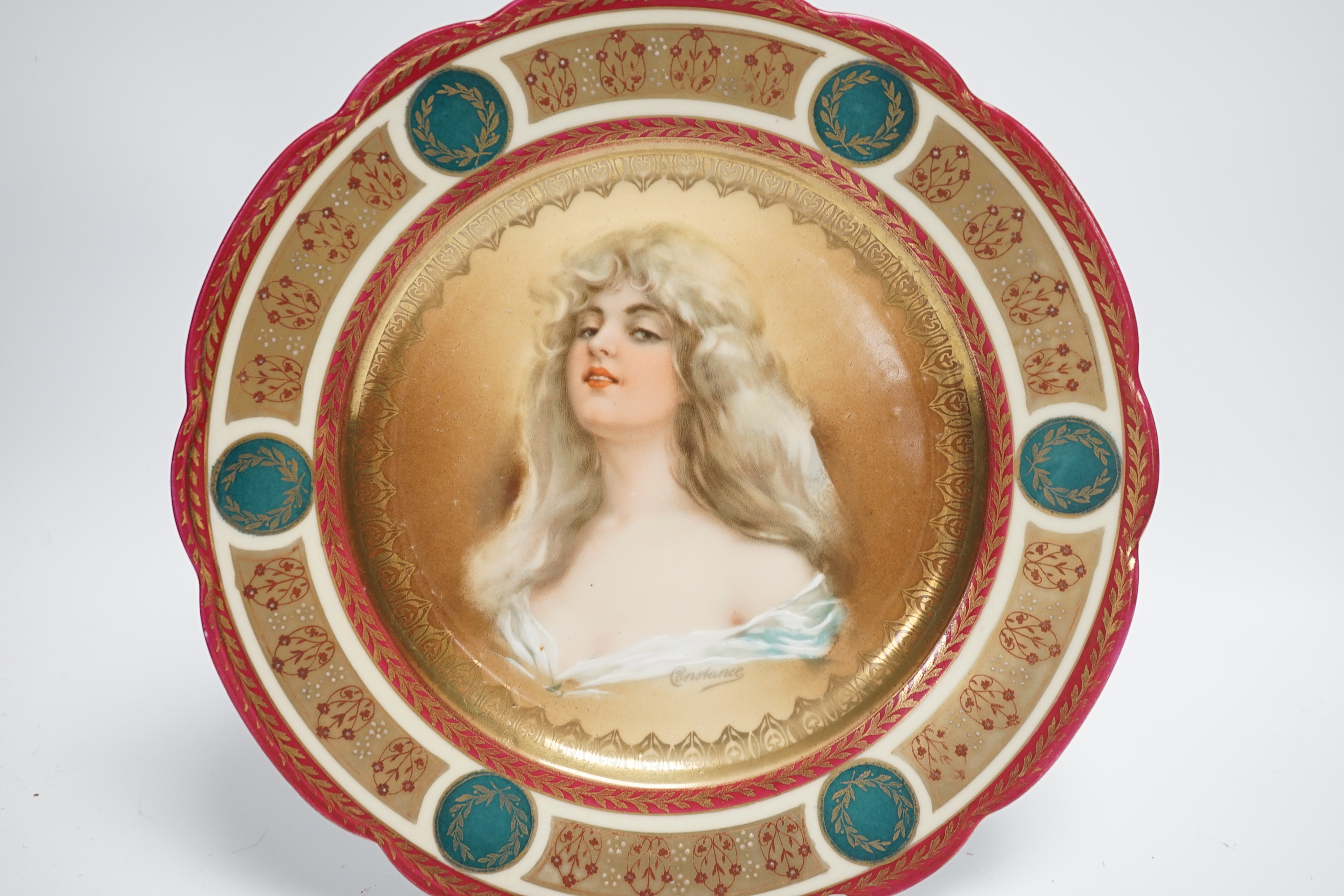 Two early 20th century Vienna style cabinet plates painted and enamelled with portraits and a Sevres style cabinet plate, 24cm (3)